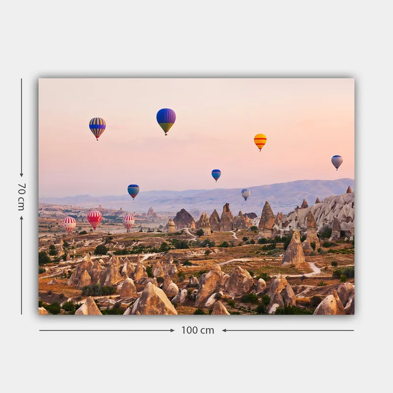 Lærred 70x100 cm - Adskillige farverige varmluftsballoner svæver over et dramatisk landskab med unikke klippeformationer - Blå / Rød / Orange - Boligtilbehør - Billeder & kunst - Billeder på lærred