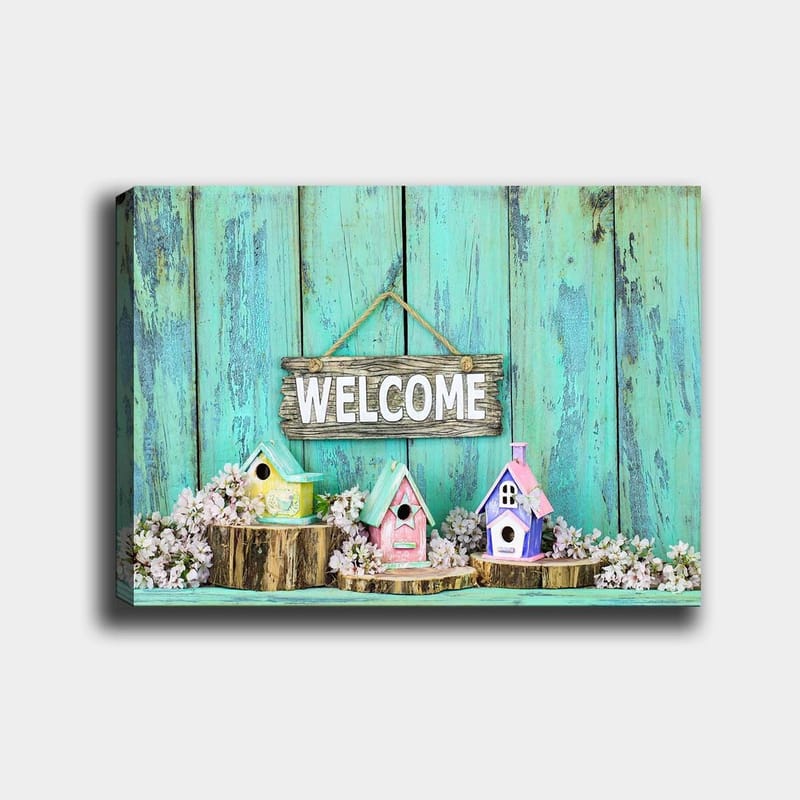 Lærred 70x100 cm - Farverige fuglehuse i et indbydende miljø med et træskilt, Turkis / Pink / Gul