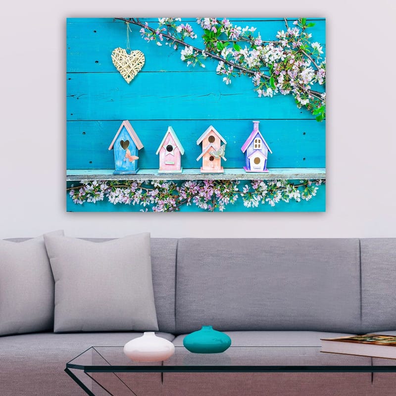 Lærred 70x100 cm - Farverige fuglehuse på en blå baggrund med blomster som dekoration, Blå / Lyserød / Hvid