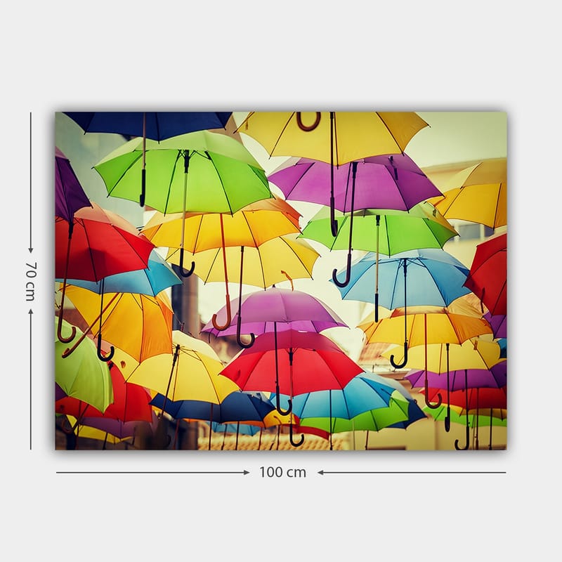 Lærred 70x100 cm - Farverige paraplyer, der hænger i luften, skaber en livlig og legende atmosfære - Grøn / Gul / Rød - Boligtilbehør - Billeder & kunst - Billeder på lærred