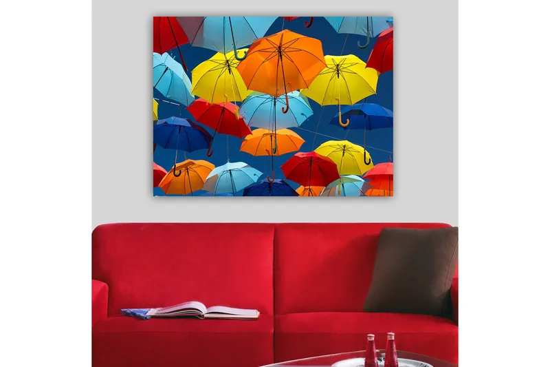 Lærred 70x100 cm - Farverige paraplyer svæver i luften, Rød / Blå / Gul