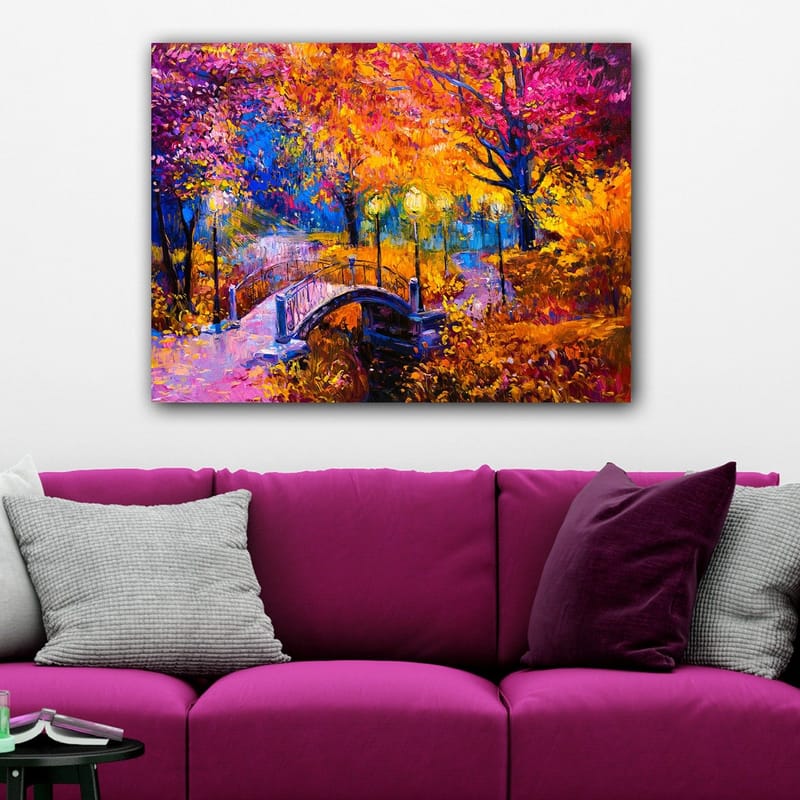 Lærred 70x100 cm - Farverigt efterårsscene med en bro, der spænder over en stille vandoverflade, omgivet af træer i varme efterårsfarver - Orange / Lilla / Gul - Boligtilbehør - Billeder & kunst - Billeder på lærred