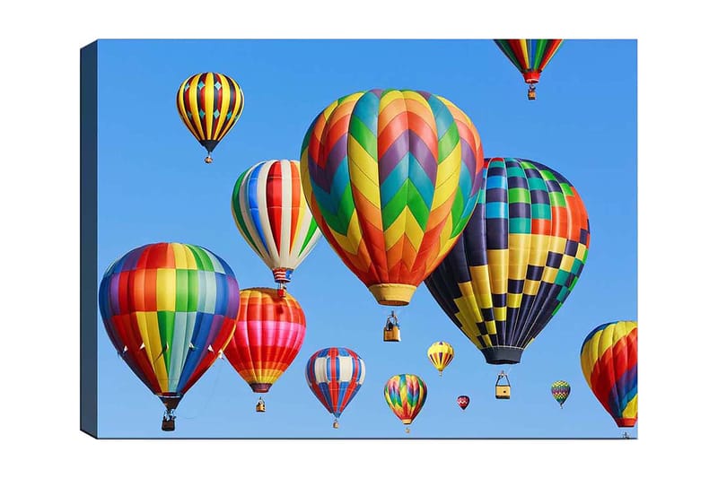 Lærred 70x100 cm - Flere farverige varmluftsballoner svæver på en klar blå himmel, Rød / Grøn / Gul