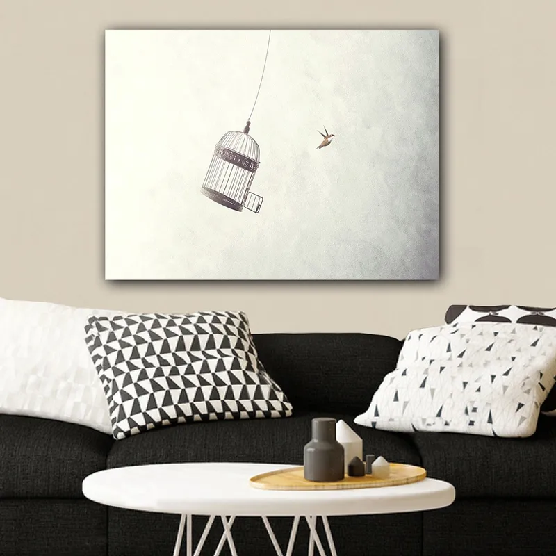 Lærred 70x100 cm - Fuglebur hængende i luften med en fugl der flyver i nærheden, Grå / Sort / Hvid