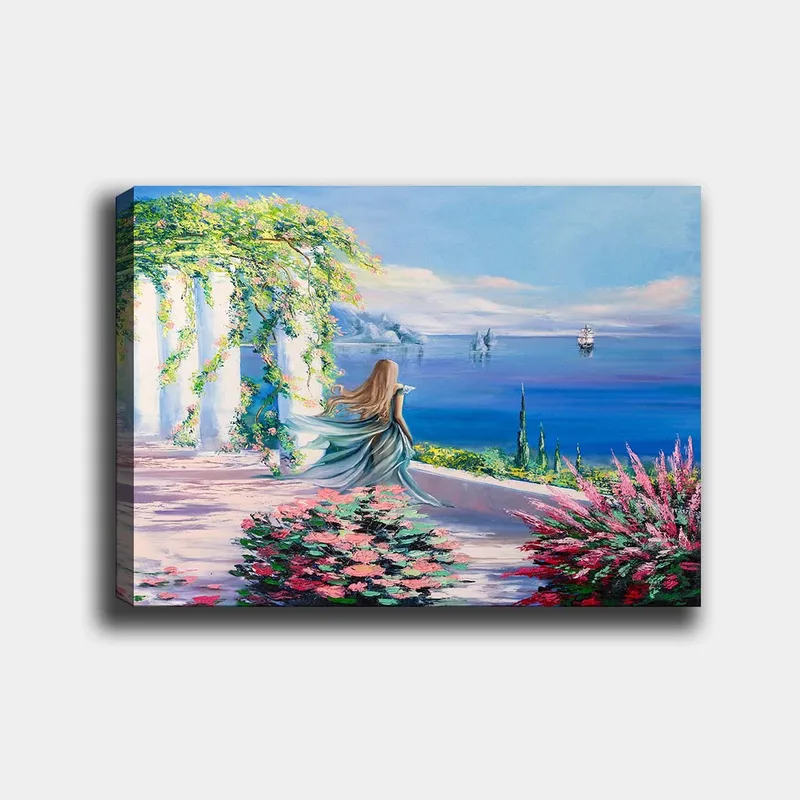 Lærred 70x100 cm - Kvinde i blå kjole stående ved et udsigtspunkt med havet og sejlbåde i baggrunden, Blå / Grøn / Lyserød