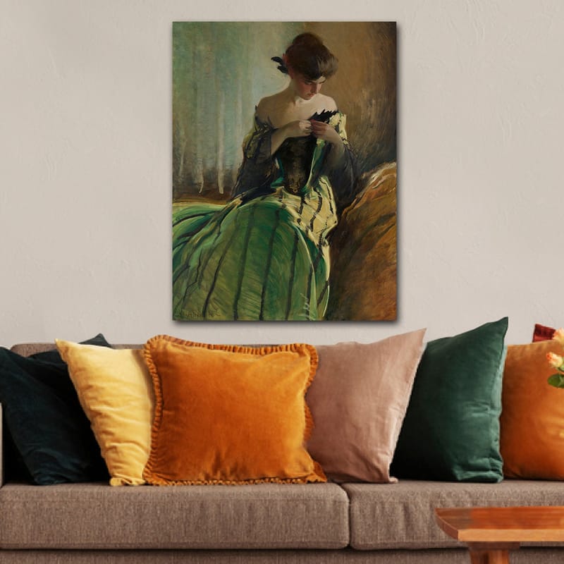 Lærred 70x100 cm - Kvinde i grøn kjole sidder og arbejder med noget i hænderne, dybt fordybet i tanker - Grøn / Sort / Beige - Boligtilbehør - Billeder & kunst - Billeder på lærred