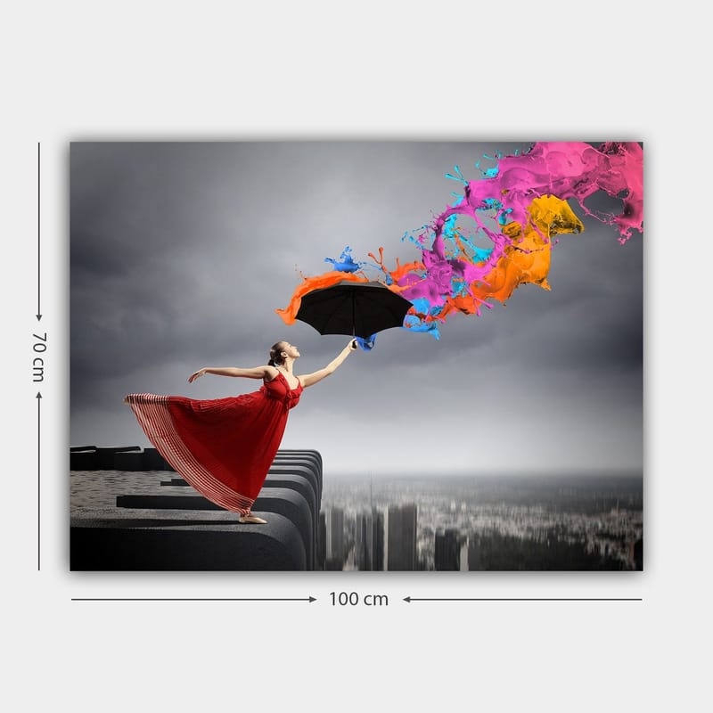 Lærred 70x100 cm - Kvinde i rød kjole står på en kant og holder en paraply, mens farverige malingsstråler sprøjter ud fra den - Rød / Sort / Orange - Boligtilbehør - Billeder & kunst - Billeder på lærred