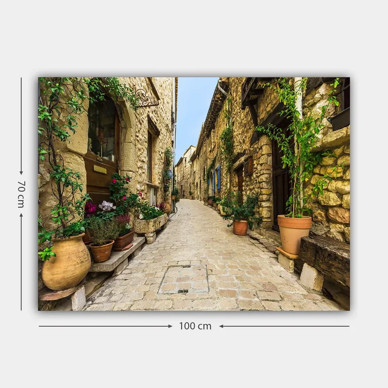 Lærred 70x100 cm - Malerisk gyde i en gammel landsby med stenhuse og blomsterpotter - Beige / Grøn / Terrakotta - Boligtilbehør - Billeder & kunst - Billeder på lærred