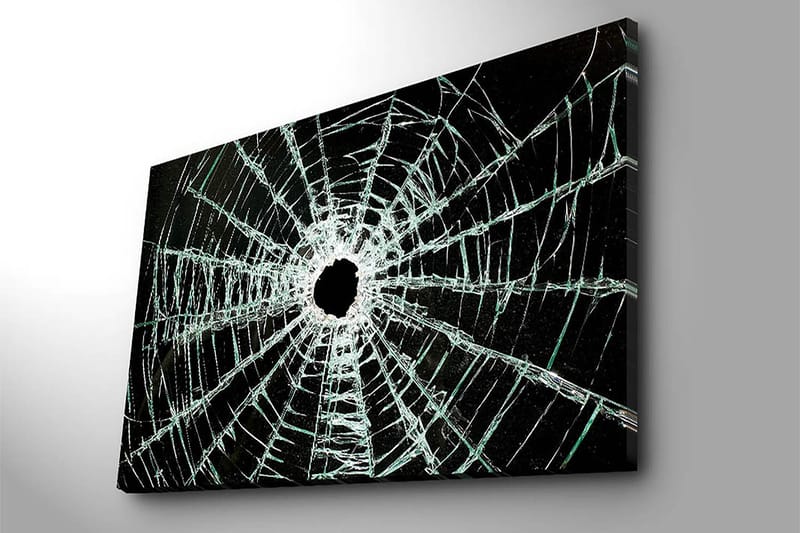 Lærred 70x100 cm - Nærbillede af en revnet glasrude med et hul i midten og revner, der strækker sig udad - Sort / Gennemsigtig - Boligtilbehør - Billeder & kunst - Billeder på lærred
