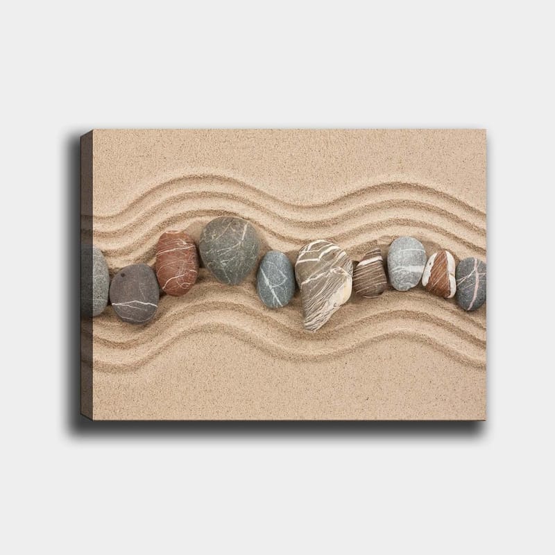 Lærred 70x100 cm - Række af glatte sten placeret på en sandet overflade med bølgede mønstre, Sandbeige / Grå / Rødbrun