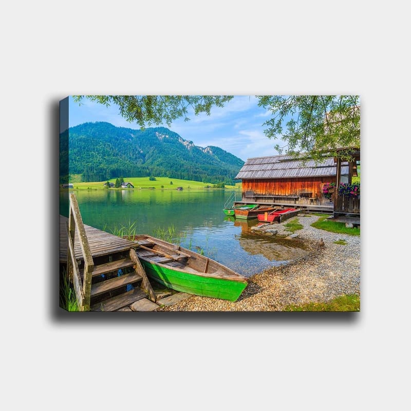 Lærred 70x100 cm - Rolig sø med farverige både ved en træmole og omkringliggende grønne bjerge, Grøn / Blå / Brun