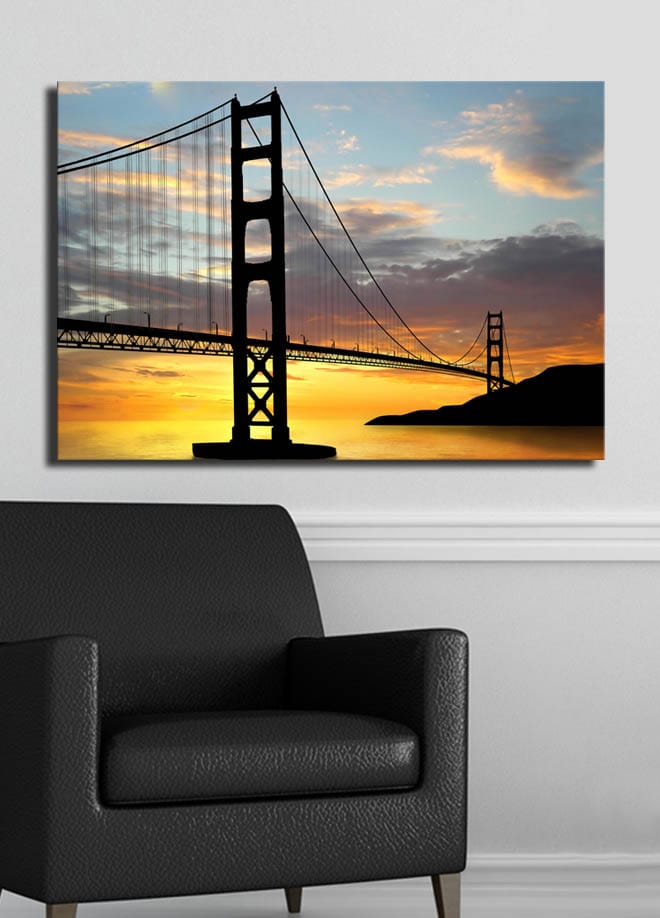 Lærred 70x100 cm - Silhuet af en bro mod en farverig solnedgang - Orange / Sort / Blå - Boligtilbehør - Billeder & kunst - Billeder på lærred