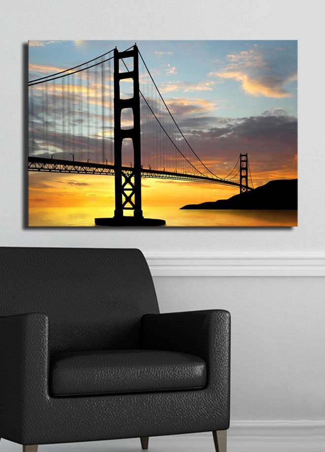 Lærred 70x100 cm - Silhuet af en bro mod en farverig solnedgang - Orange / Sort / Blå - Boligtilbehør - Billeder & kunst - Billeder på lærred