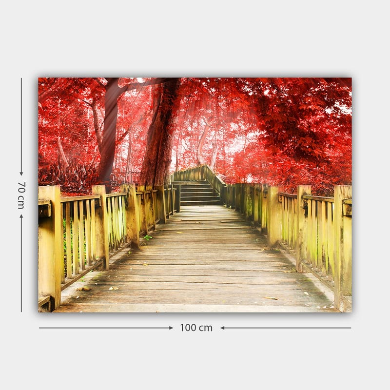 Lærred 70x100 cm - Smuk træbro omgivet af lyserøde træer i efterårsfarver - Rød / Gulgrøn - Boligtilbehør - Billeder & kunst - Billeder på lærred