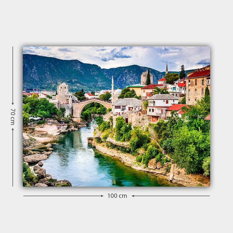 Lærred 70x100 cm - Smuk udsigt over en historisk bro, der spænder over en flod, omgivet af maleriske huse og frodige grønne områder - Grøn / Blå / Rød - Boligtilbehør - Billeder & kunst - Billeder på lærred