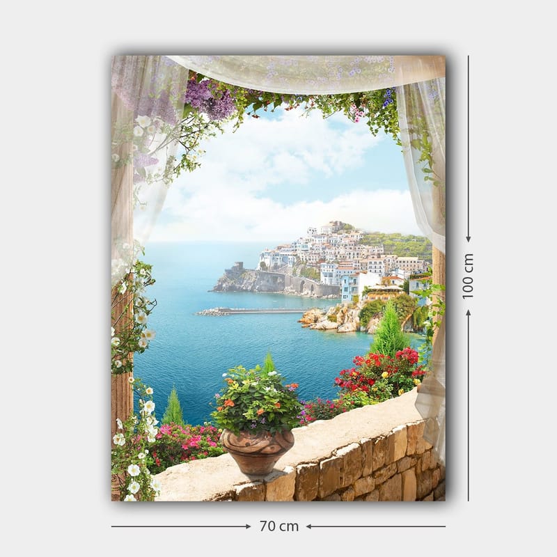 Lærred 70x100 cm - Smuk udsigt over en kystby med farverige huse og blomstrende planter, set gennem en åben vinduesåbning - Blå / Grøn / Hvid - Boligtilbehør - Billeder & kunst - Billeder på lærred