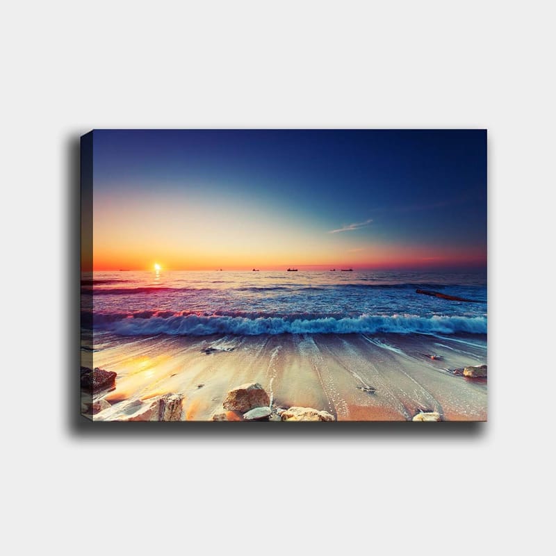 Lærred 70x100 cm - Solnedgang over havet med bløde bølger, der ruller ind mod kysten - Blå / Orange / Lyserød - Boligtilbehør - Billeder & kunst - Billeder på lærred