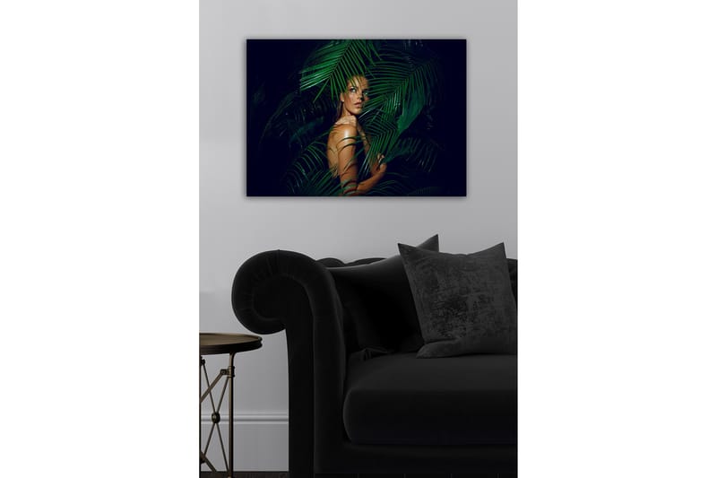 Lærredsbillede - Kvinde delvist skjult bag grønne palmeblade - Mørkegrøn / Hudtone / Sort - Boligtilbehør - Billeder & kunst - Billeder på lærred