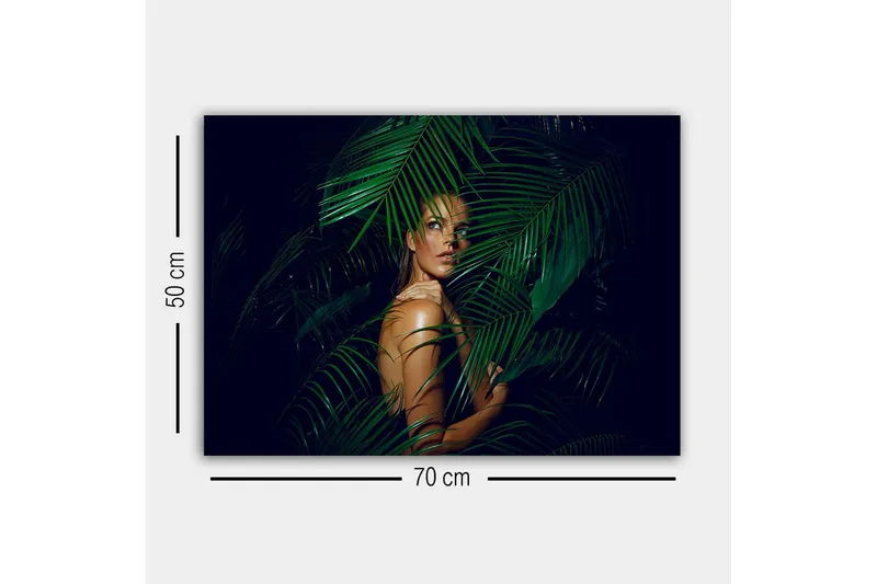 Lærredsbillede - Kvinde delvist skjult bag grønne palmeblade - Mørkegrøn / Hudtone / Sort - Boligtilbehør - Billeder & kunst - Billeder på lærred