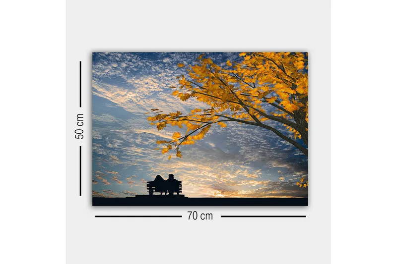 Lærredsbillede - Silhuet af et par, der sidder på en bænk under et træ med gyldne efterårsblade - Guld / Blå / Sort - Boligtilbehør - Billeder & kunst - Billeder på lærred