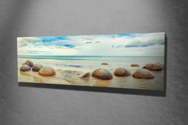 Lærredstryk 80x30 cm - Runde sten på en strand med hav og himmel i baggrunden - Blå / Beige / Grå - Boligtilbehør - Billeder & kunst - Billeder på lærred