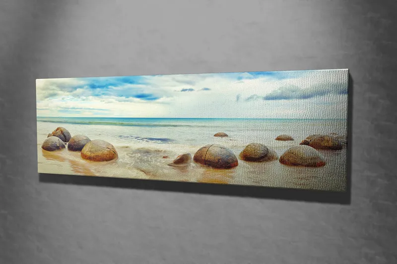Lærredstryk 80x30 cm - Runde sten på en strand med hav og himmel i baggrunden - Blå / Beige / Grå - Boligtilbehør - Billeder & kunst - Billeder på lærred